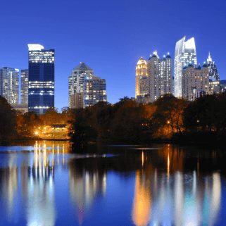 Shot of Atlanta's Skyline at night with lights reflecting of a lake