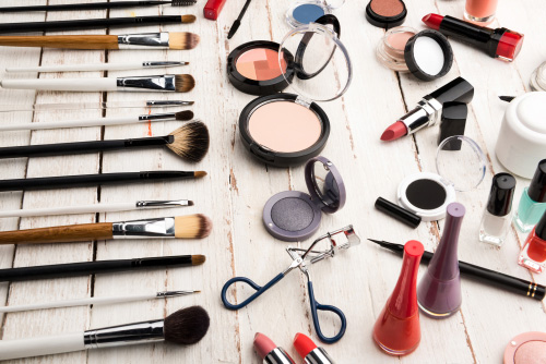 Makeup collection on white wooden boards