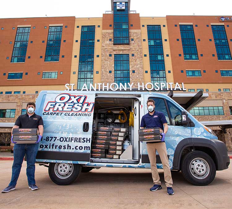 Oxi Fresh van with pre-packed meals in front of St. Anthony's Hosptial. Oxi Fresh's president Jonathan Barnett and Firehouse Subs franchisee Brandon Gerstein stand in front of the van.