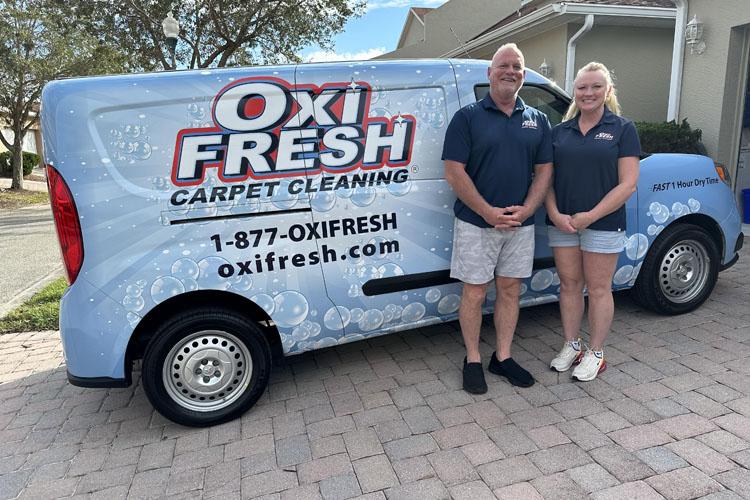 This photo shows Will Chambers and his partner in front of an Oxi Fresh van.