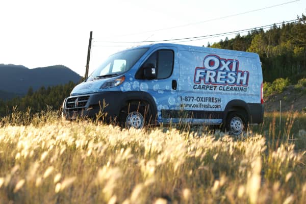 Oxi Fresh vehicle parked near a prairie.