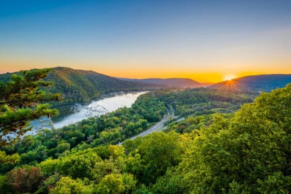 Aerial view of a sunrise over a river in the mountains of West Virginia.