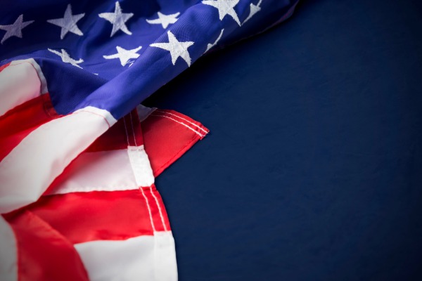 A flag folded against a navy blue background.